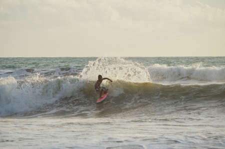 BALI, INDONESIA-MARCH 2020: Young people ride on short boards on the waves. Extreme sports and hobbies. Ocean waves. Soft focus and blurry photos while moving.のeditorial素材