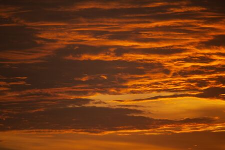 Tropical seascape. Stunning dramatic sunset over the ocean. Huge cumulus clouds colored by the setting sun. Stunning cloud color during sunset.の写真素材