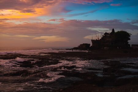 Sacred temple of Tanah Lot on a stone rock in the ocean.の写真素材