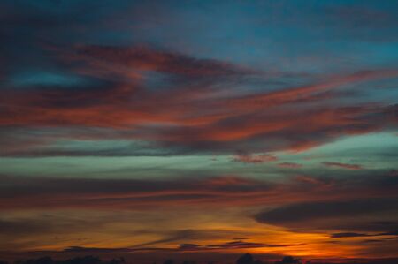 Tropical seascape. Stunning dramatic sunset over the ocean. Huge cumulus clouds colored by the setting sun. Beach holidays with sea views in the evening.の写真素材