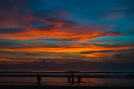 Tropical seascape. Stunning dramatic sunset over the ocean. Huge cumulus clouds colored by the setting sun. Beach holidays with sea views in the evening.の写真素材
