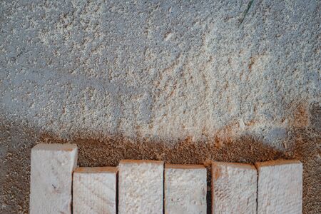 Sawdust after sawing wooden blocks on the floor close-up. Woodwork and repair materials. Soft focus. Repair and woodwork. Soft focus, tinting and close-ups.の写真素材