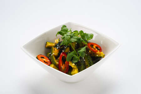 Traditional oriental salad of fresh vegetables in a deep white bowl on a white background, isolate.の写真素材