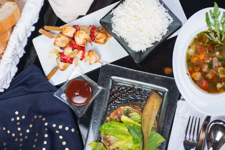Top view of a restaurant table served with a multi-course set lunch and drink. Complex lunch.の写真素材