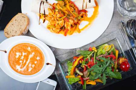 Top view of a restaurant table served with a multi-course set lunch and drink. Complex lunch.の写真素材