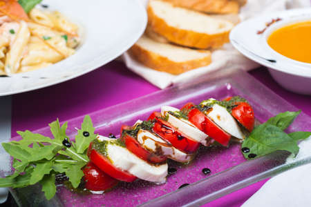 Classic Italian caprese salad with tomatoes and mozzarella.の写真素材