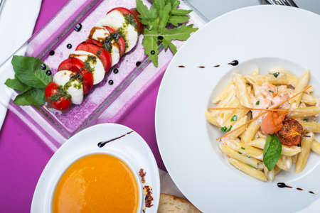 Top view of a restaurant table served with a multi-course set lunch and drink. Complex lunch.の写真素材