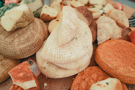 Counter at farmers market, a variety of homemade cheese. Assortment of cheese. Soft, hard, cheese...