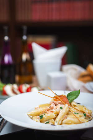 Traditional Italian pasta penne with salmon and creamy sauce.の写真素材