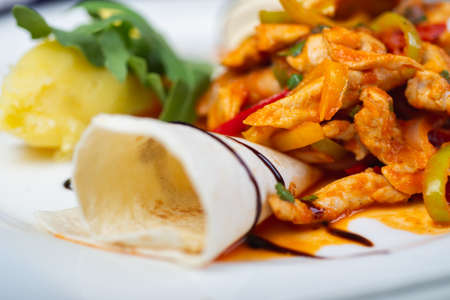Traditional Caucasian meat in a tortilla with spices and seasonings is wrapped in a tube.の写真素材