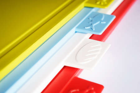 Multicolored bright plastic boards for cutting vegetables, bread, meat and other products on a white background.の写真素材