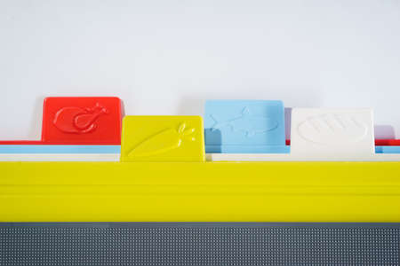 Multicolored bright plastic boards for cutting vegetables, bread, meat and other products on a white background.の写真素材