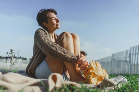 Autumn picnic: girl knitted sweaterの写真素材