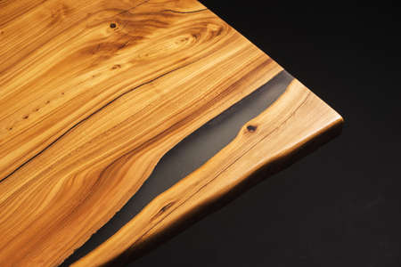 Style wooden countertop slab, saw cut wood treated with varnish close-up on black. Isolate.の写真素材