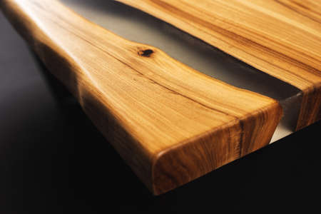 Style wooden countertop slab, saw cut wood treated with varnish close-up on black. Isolate.の写真素材