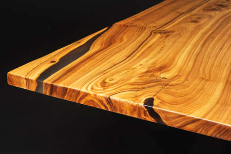 Style wooden countertop slab, saw cut wood treated with varnish close-up on black. Isolate.の写真素材