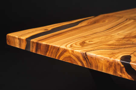 Style wooden countertop slab, saw cut wood treated with varnish close-up on black. Isolate.の写真素材