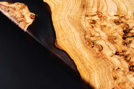 Slab and countertop, saw cut wood treated varnish close-up on a black background. Isolate. Luxury wood for countertops and tables. Design materials, details for presentation and shop. Concept.の写真素材