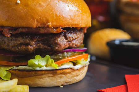 Delicious burger with organic cutlet with fried potatoes.の写真素材
