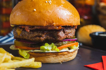 Delicious burger with organic cutlet with fried potatoes.の写真素材