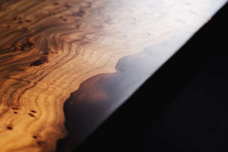 Slab and dark countertop, saw cut wood treated varnish close-up on a black background. Isolate. Luxury wood for countertops and tables. Design materials, details for presentation and shop. Concept.の写真素材
