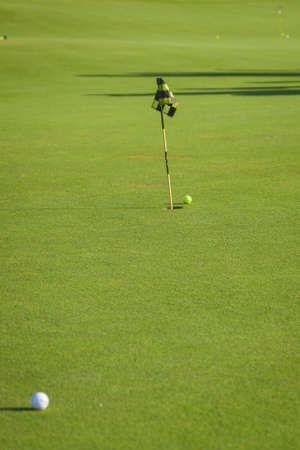 Golf course. Summer landscape overlooking the hills of the golf course. Holes and sand traps in the field. Summer hobbies and sports. Golf Club.の写真素材