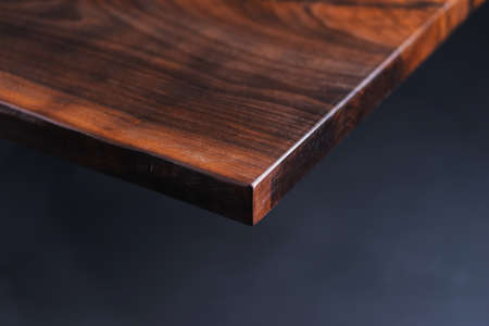 Slab and dark countertop, saw cut wood treated varnish close-up on a black background. Isolate. Luxury wood for countertops and tables. Design materials, details for presentation and shop. Concept.の写真素材