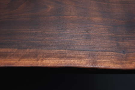 Style wooden countertop slab, saw cut wood treated with varnish close-up on black. Isolate.の写真素材