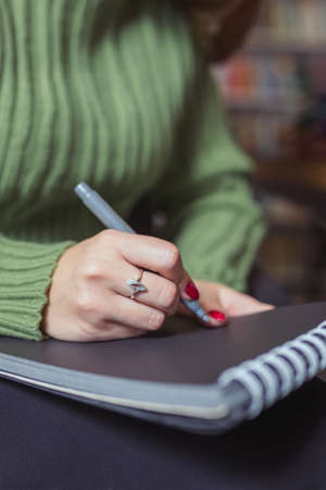 Girl writes down a summary of the training session in a notebook.の写真素材