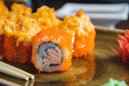 Set of traditional Japanese rolls Philadelphia and California on a plate with wooden chopsticksの写真素材