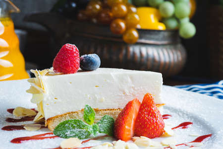 Piece of classic cheesecake with strawberries on a plateの写真素材