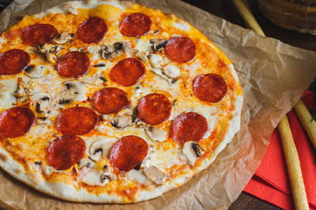 Traditional Italian pizza pepperoni with cheese and mushrooms.の写真素材