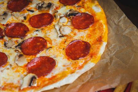 Traditional Italian pizza pepperoni with cheese and mushrooms.の写真素材