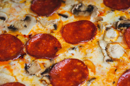 Traditional Italian pizza pepperoni with cheese and mushrooms.の写真素材