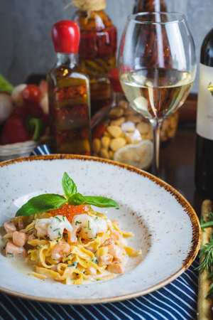 Traditional Italian pasta Carbonara with salmon and red caviar on a plateの写真素材