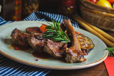 Fried ribs with a glass of red wine on a table in a restaurant close-upの写真素材
