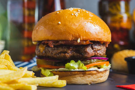 Delicious burger with organic cutlet with fried potatoes.の写真素材