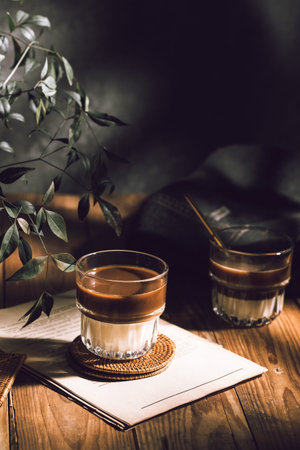 Coffee in a glass cup on a wooden table. Still life