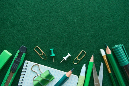 Stationery set on green background. School supplies top view for advertising and promotional items....