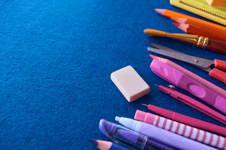 Stationery set on blue background. School supplies top view for advertising and promotional items. Back to school conceptの写真素材