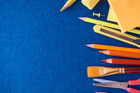 Stationery set on blue background. School supplies top view for advertising and promotional items....