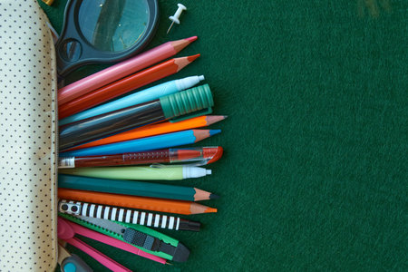Stationery set on green background. School supplies top view for advertising and promotional items....