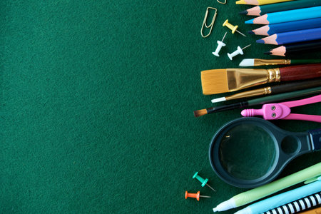 Stationery set on green background. School supplies top view for advertising and promotional items....