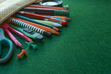 Stationery set on green background. School supplies top view for advertising and promotional items....