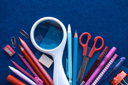 Stationery set on blue background. School supplies top view for advertising and promotional items. Back to school conceptの写真素材