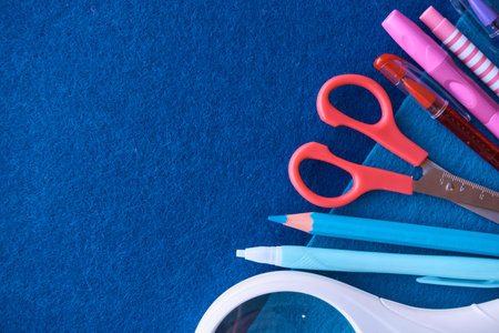 Stationery set on blue background. School supplies top view for advertising and promotional items....
