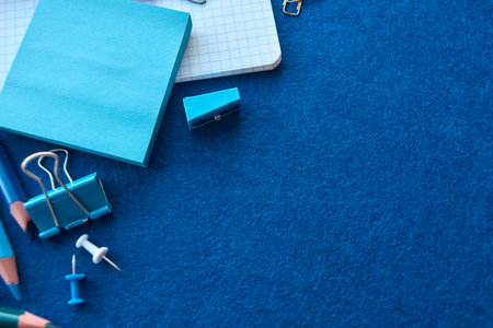 Stationery set on blue background. School supplies top view for advertising and promotional items....
