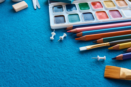 Art materials, products for drawing. Stationery set on blue background