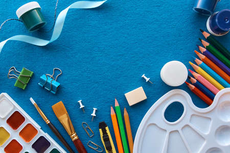Art materials, products for drawing. Stationery set on blue backgroundの写真素材
