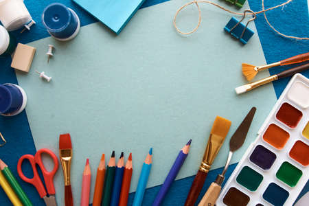 Art materials, products for drawing. Stationery set on blue backgroundの写真素材